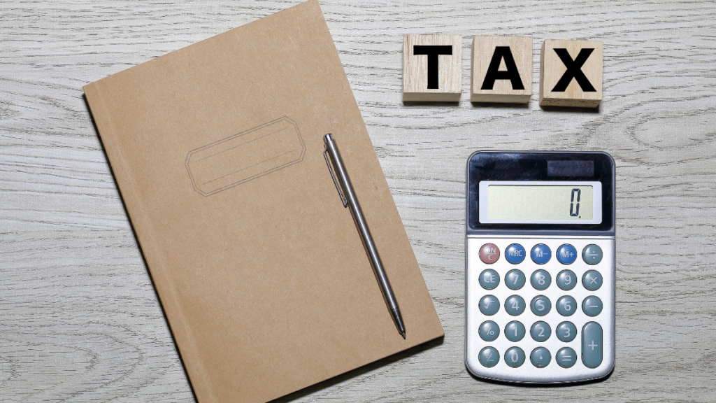 Tax letters, calculator and folder on desk