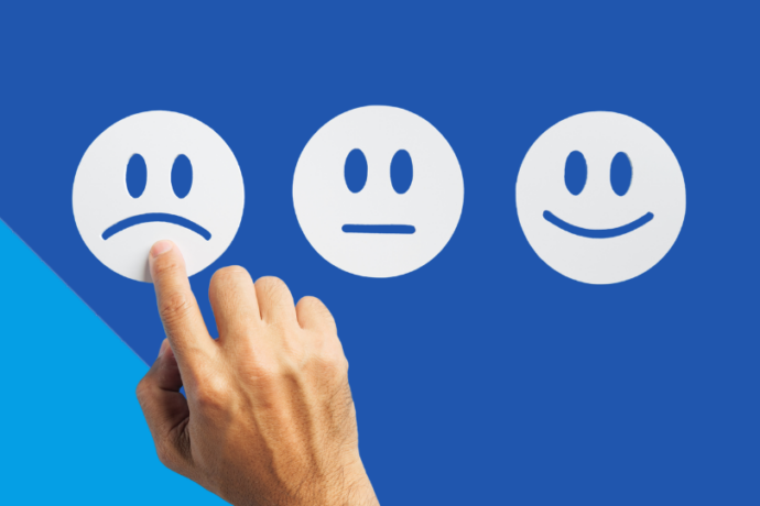 Finger points on sad face of three point satisfaction scale