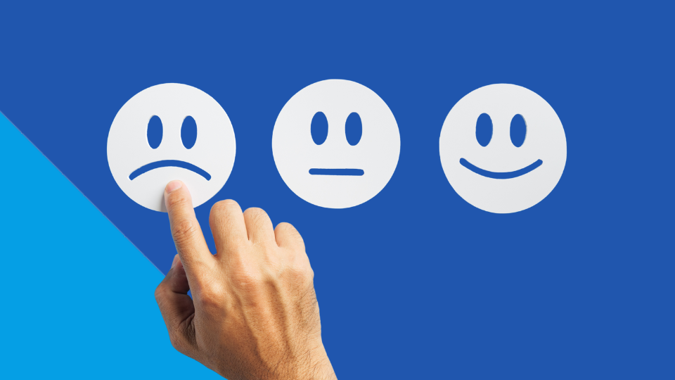 Finger points on sad face of three point satisfaction scale